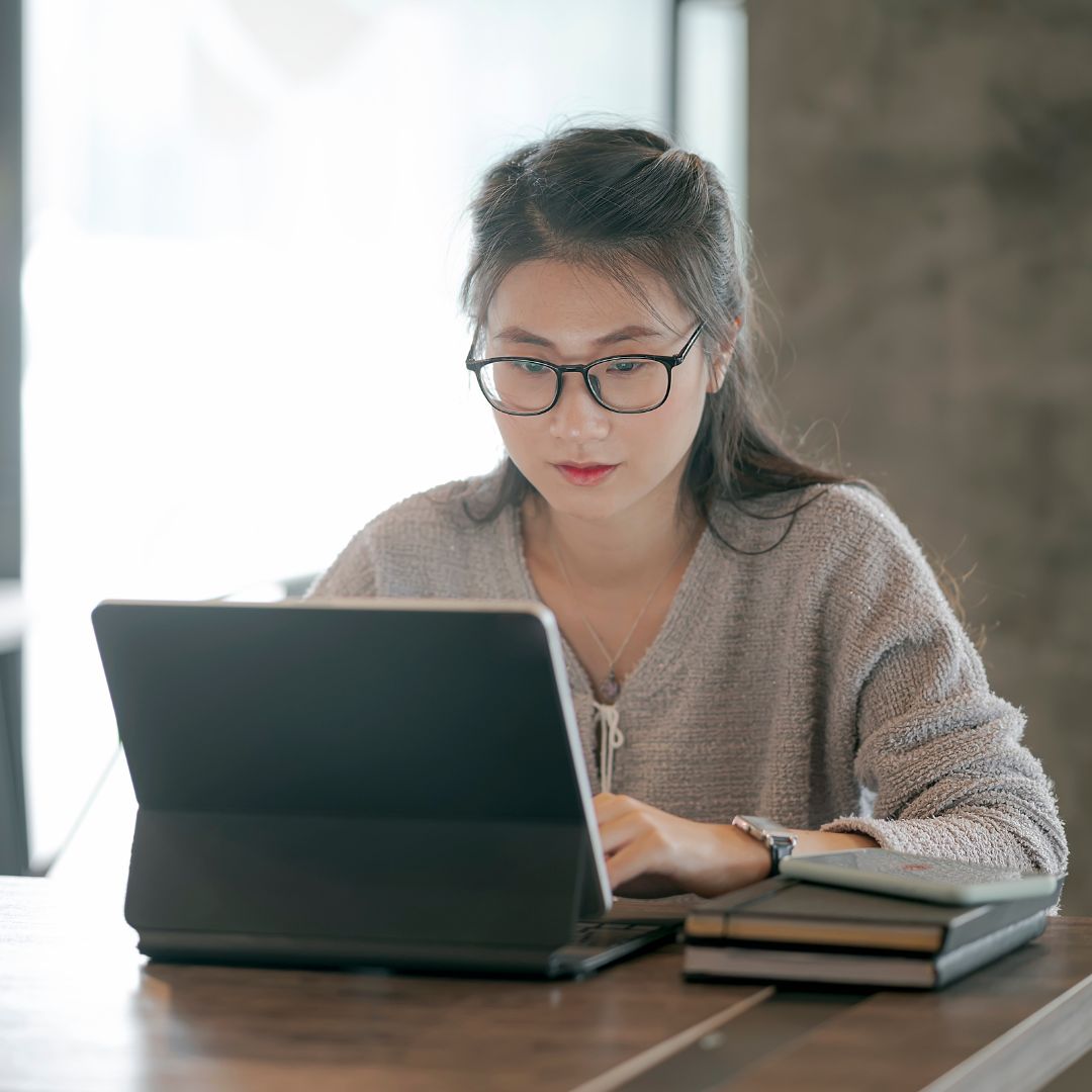 woman using a tablet taking online course