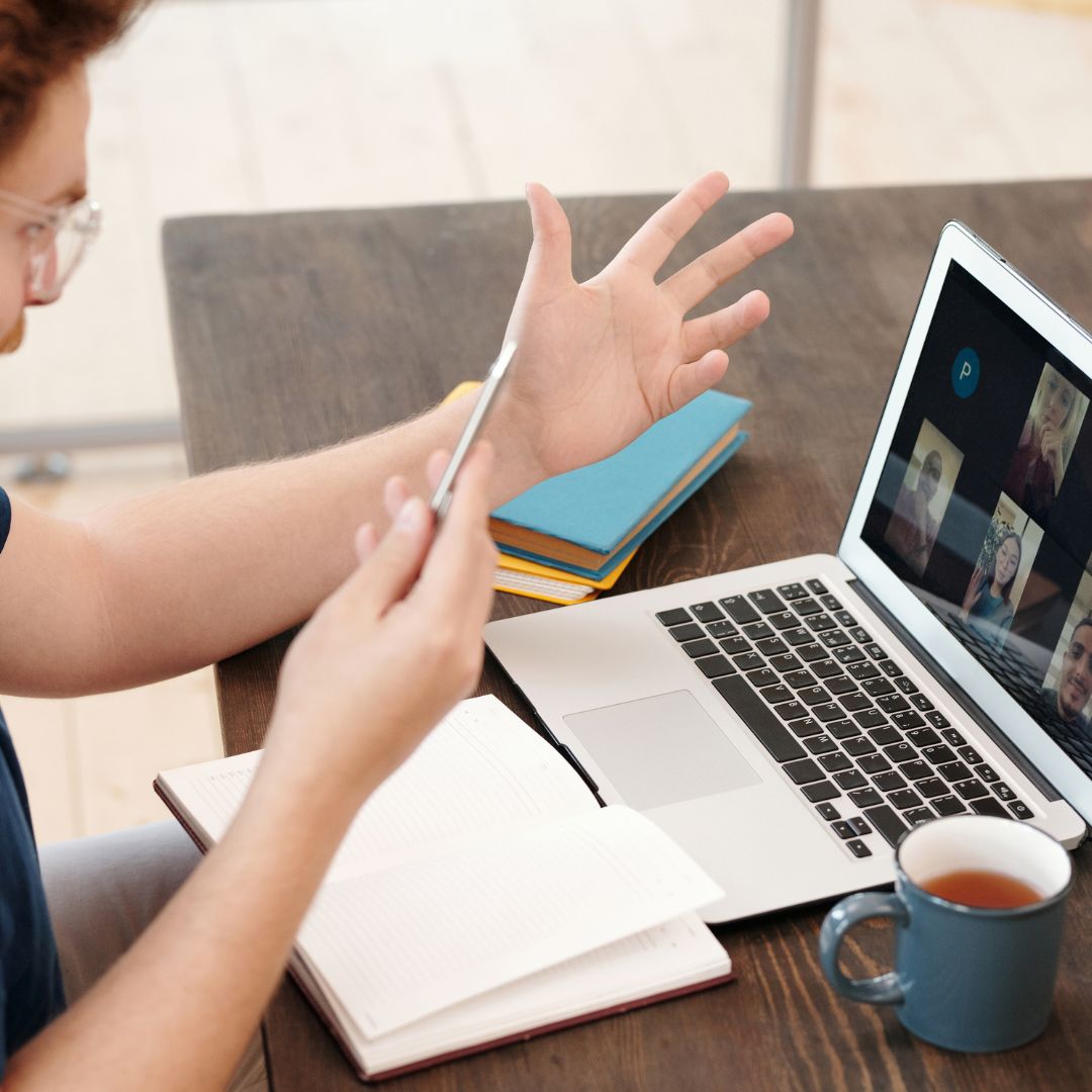 Man talking to other classmates on video call