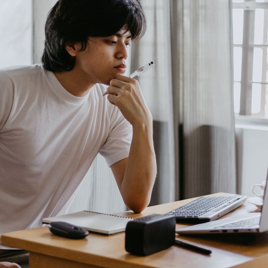 Man looking at his computer and thinking